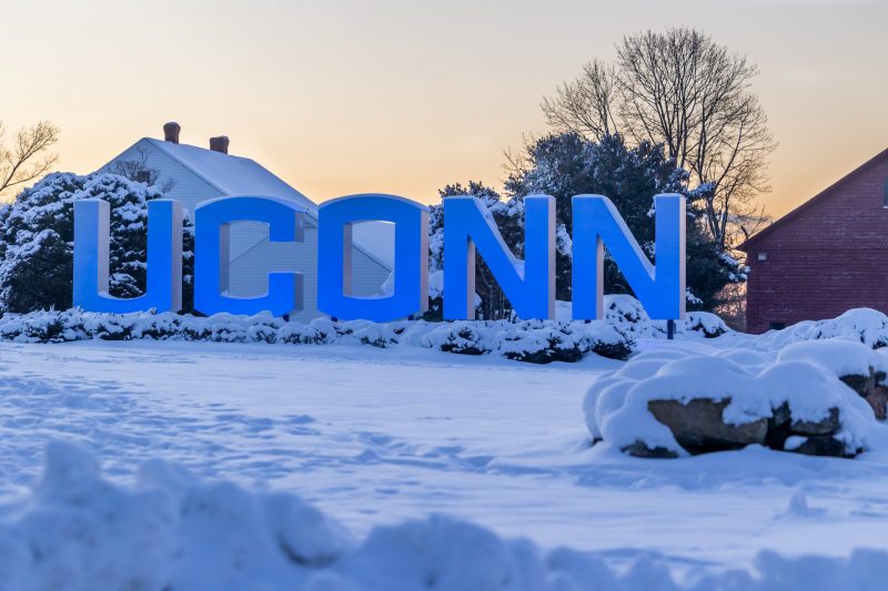 Snow sits on the UConn gateway sign in Storrs after the first snowstorm of the season on Jan. 8, 2024. (Sydney Herdle/UConn Photo)